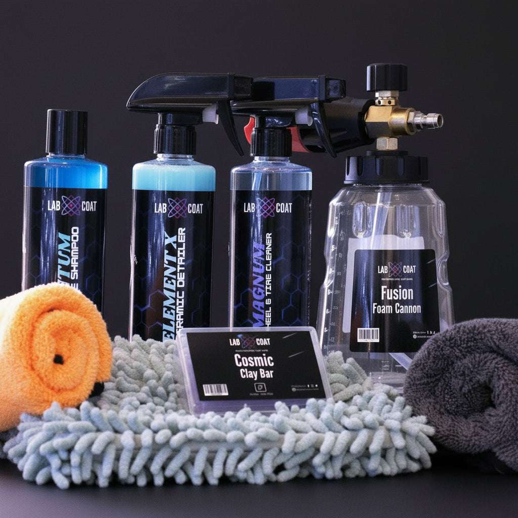 Automotive care products including bottles and cloths on a textured surface with a blurred Christmas tree background.